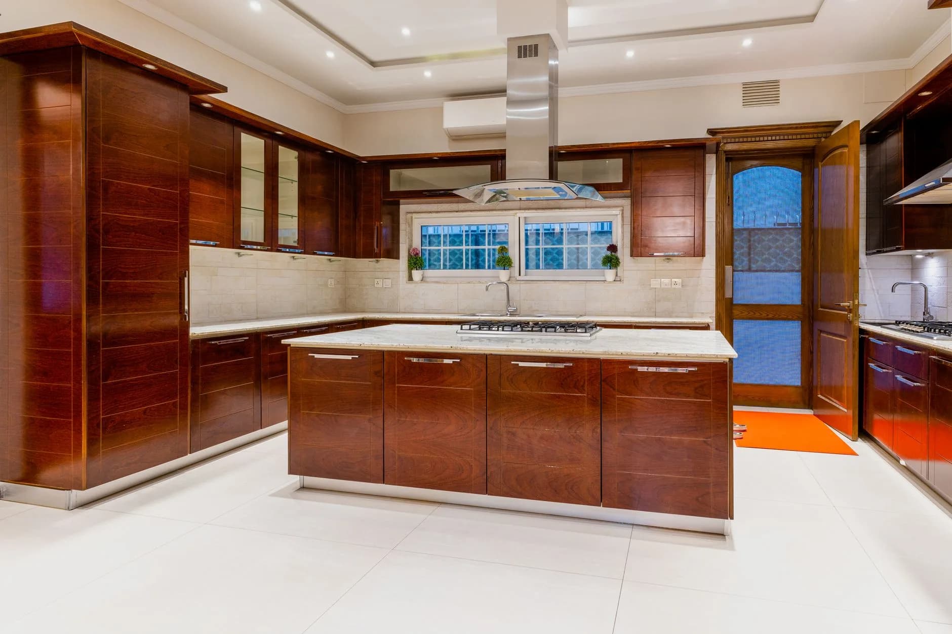 Contemporary kitchen with marble counters and integrated appliances